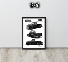 A framed 12x16 vintage truck art print leaning against a light gray wall on a light wood floor. The black-framed poster shows three black-and-white illustrations of a classic pickup truck from different angles, with the text 'JEKEONE' and '1934' on the print.