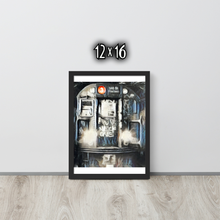 Framed artwork of the front of a graffiti marked up subway train on a white wall with '12x16' text.