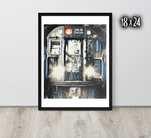 Framed artwork of the front of a graffiti marked up subway train on a white wall with '18x24' text.