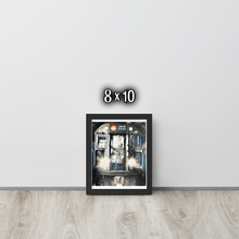 Framed artwork of the front of a graffiti marked up subway train on a white wall with '8x10' text.